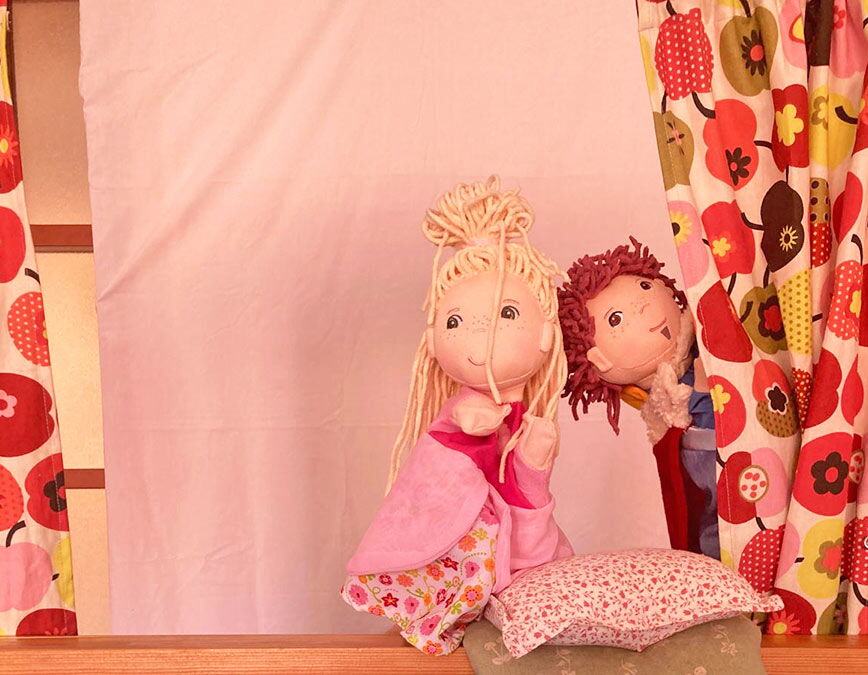 Kleines Puppentheater mit zwei niedlichen Puppen (Mädchen und Junge)